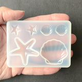 Sea Star and Shell Silicone Mold For Resin, Held In Hand