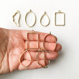 Set Of 8 Open Bezels, Gold Plated, Held In Hand